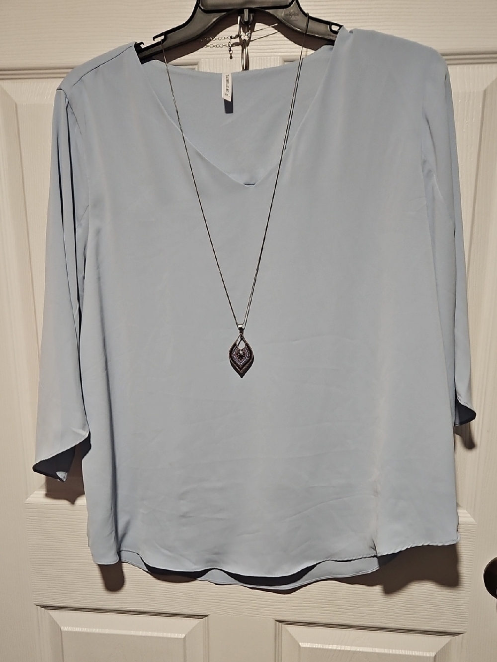 Light Blue V-Neck Blouse with Three-Quarter Sleeves